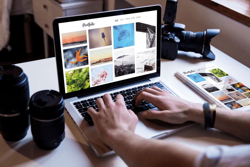 Photographer reviewing an online portfolio on a laptop, showcasing various images, with camera gear alongside, symbolizing remote work opportunities in photography.